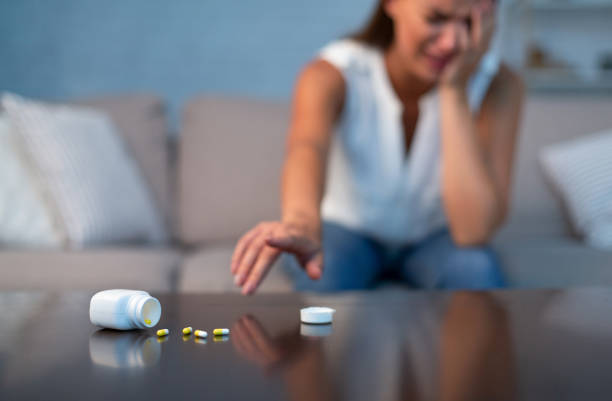 istock Woman Reaching For Sleeping Pills Sitting On Sofa At Home 1179519702