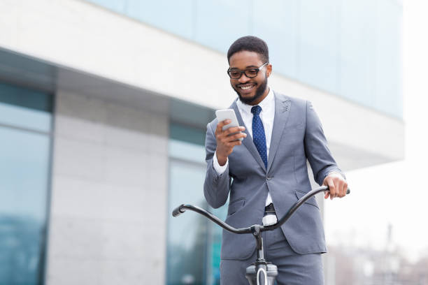 istock Excited businessman using phone against office building 1179519800