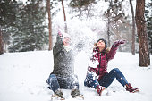 Two women throwing snow
