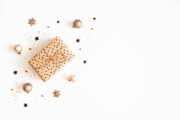 Christmas composition. Gift box, beige and black decorations on white background. Christmas, winter, new year concept. Flat lay, top view, copy space