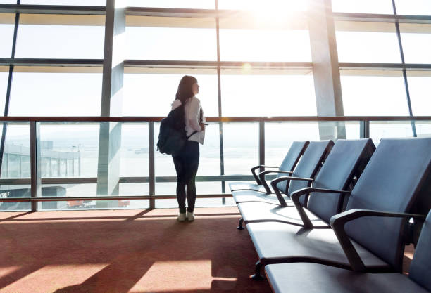 istock Woman with backpack waiting in airport 1179523912