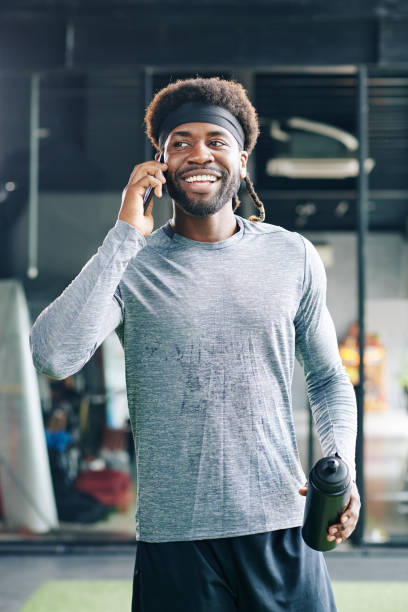 istock Sweaty sportsman talking on phone 1179525529