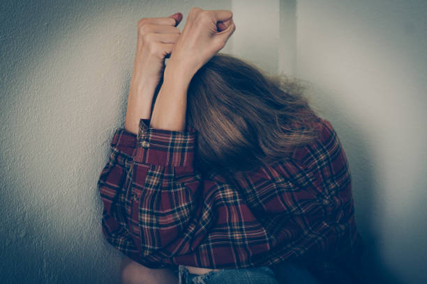 istock Depressed woman covering her face 1179526959