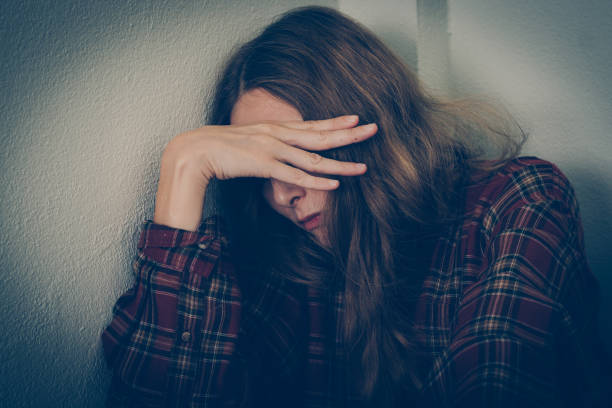 istock Depressed woman covering her face 1179527014