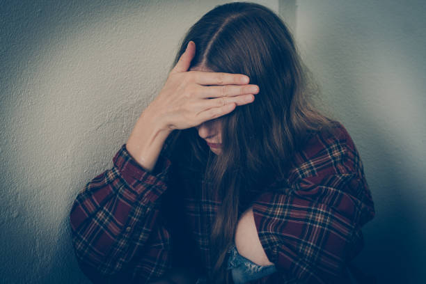 istock Depressed woman covering her face 1179527061
