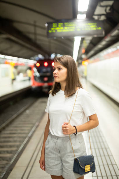 istock Woman waiting subway car on platform 1179527325