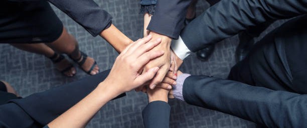 istock Business teamwork groups people hands, stacked huddle together, showing unity and teamwork. Top view and Horizontal photo banner background. 1179527357