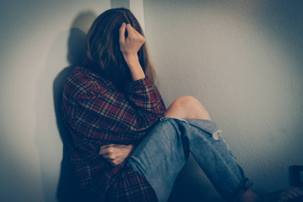 istock Depressed woman covering her face 1179527440