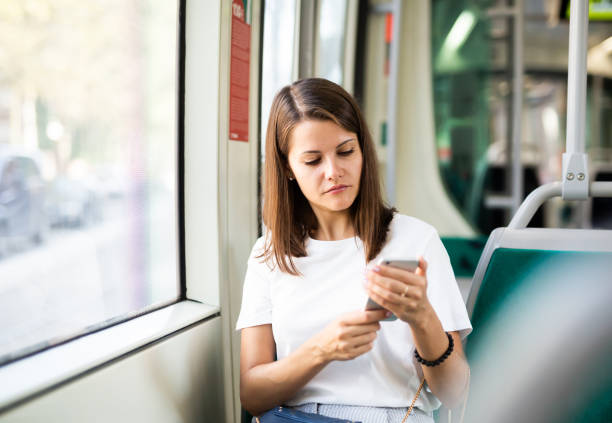 istock Woman using smartphone in public transport 1179527504