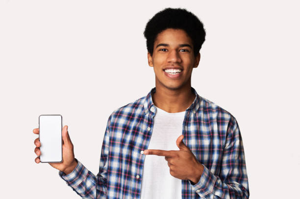 istock Happy black guy holding smartphone with blank screen 1179528679