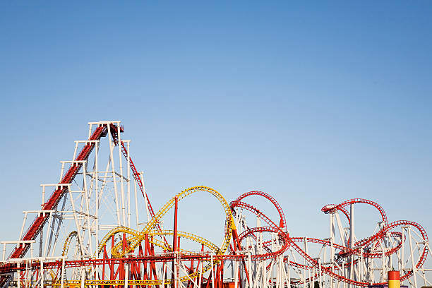 a selection of large roller coasters intertwined together - lunapark treni stok fotoğraflar ve resimler