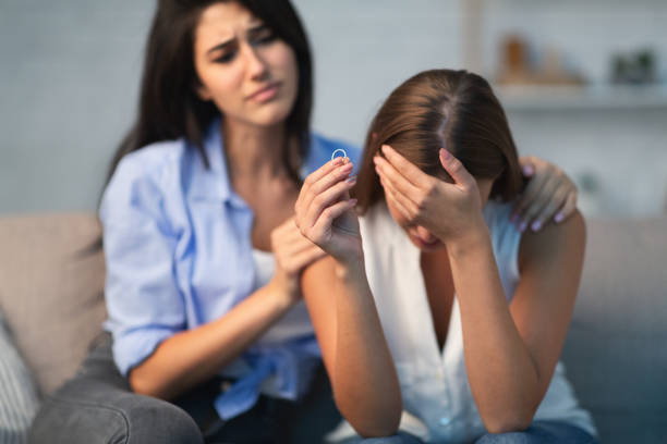 istock Compassionate Young Woman Supporting Depressed Divorced Friend At Home 1179530198