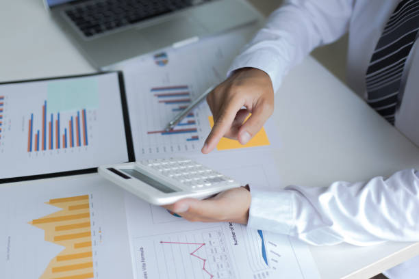istock Midsection Of Businessman Using Calculator At Desk In Office 1179532096