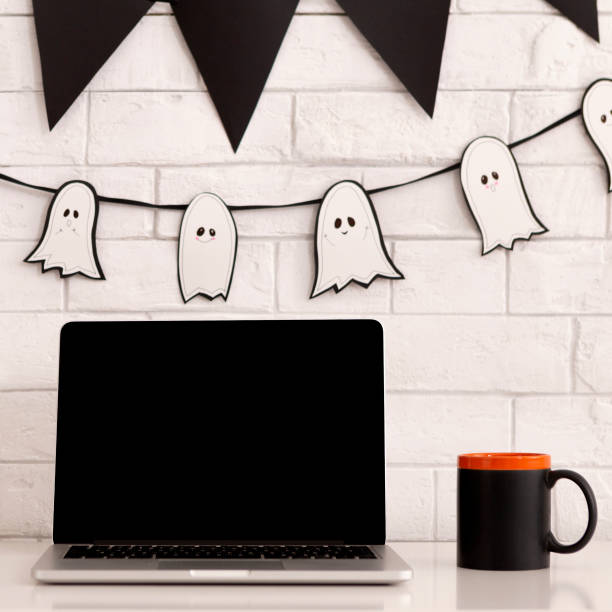 istock Desktop with laptop and scary holiday decorations 1179532112