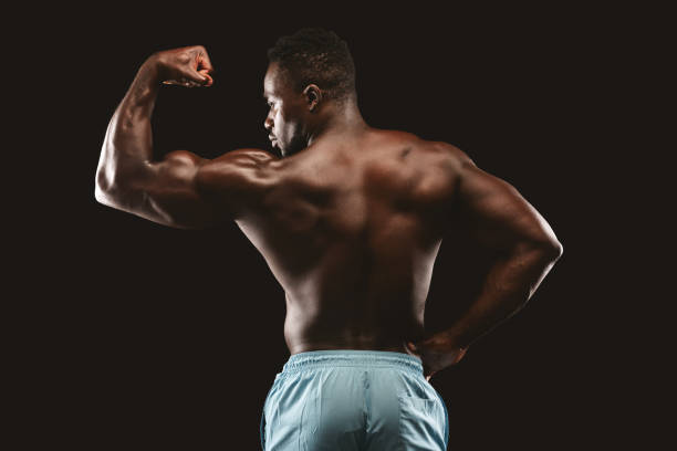 istock Strong afro bodybuilder demonstrating his muscular biceps 1179532305
