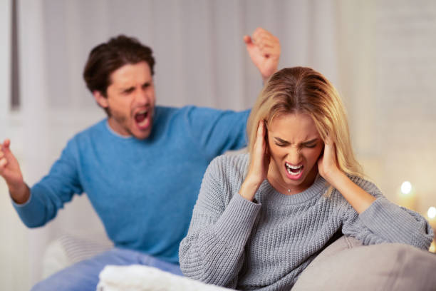 istock Man Yelling At Girlfriend Sitting On Sofa At Home 1179532355