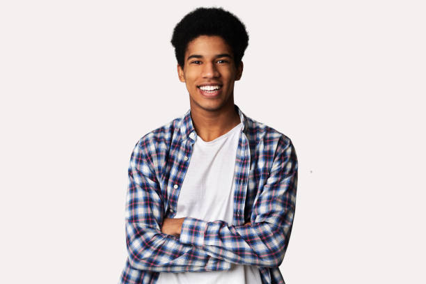 istock Happy teen guy posing with crossed hands over white background 1179533196