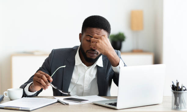 istock Overworked businessman sitting at workplace after hard day in office 1179535865