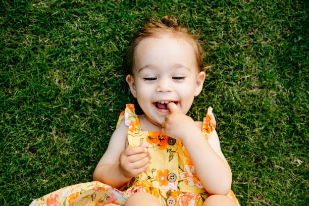 istock Happy Smiling Little Girl Lying On Grass 1179538532