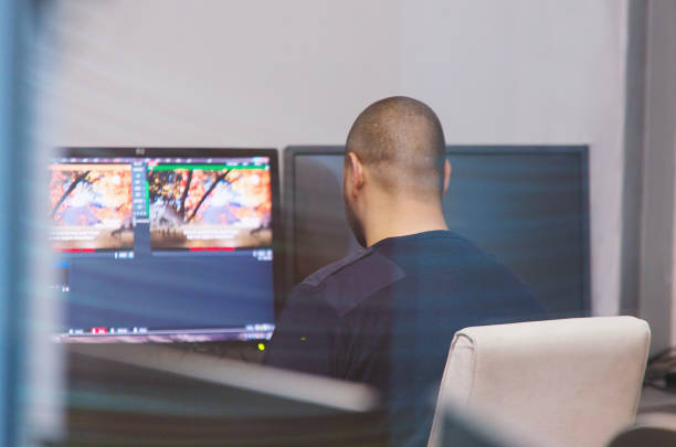 istock Rear View Of Tv Editor Working With At Workspace 1179539823