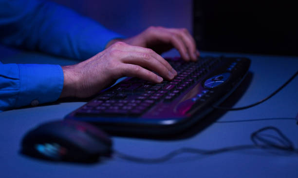 istock Gamer actively pushing buttons on keyboard, playing games 1179540972