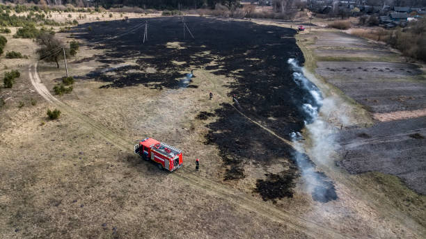 istock firefighters extinguish dry grass aerial view from a drone 1179541731