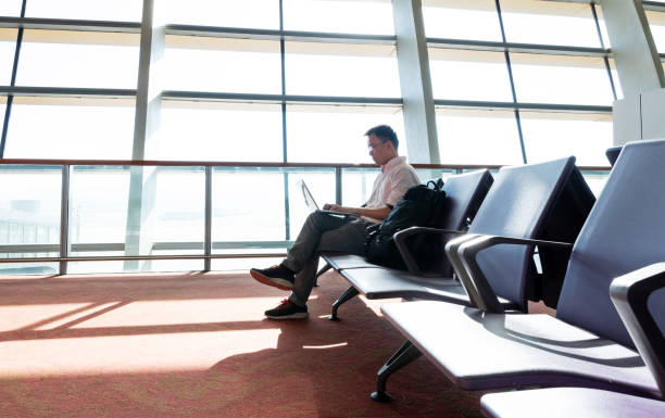istock Man working on laptop in airport 1179542417