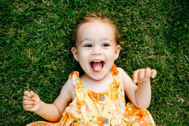istock Happy Smiling Little Girl Lying On Grass 1179543589