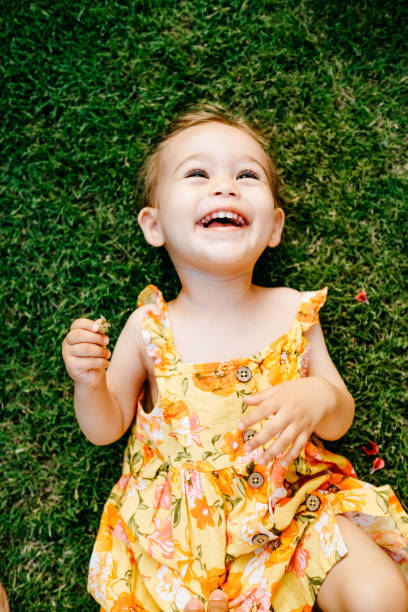 istock Happy Smiling Little Girl Lying On Grass 1179545266