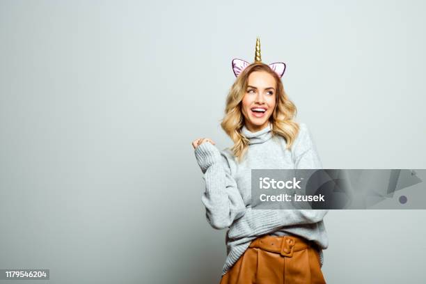 Studio Portrait Of Surprised Beautiful Woman With Unicorn Headband Stock Photo - Download Image Now