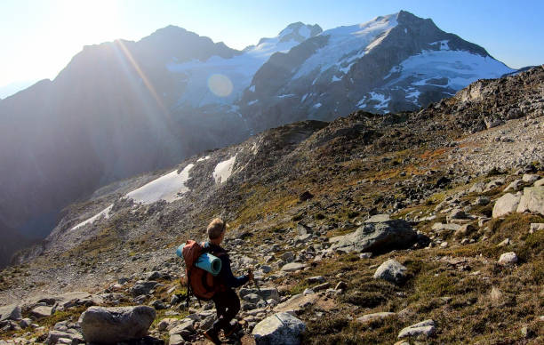 istock Male hiker crosses mountainside at sunrise 1179547047