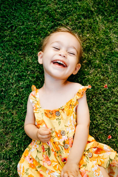 istock Happy Smiling Little Girl Lying On Grass 1179547625