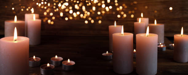 Burning candles in darkness Burning candles in darkness with light effects candlelight photos stock pictures, royalty-free photos & images