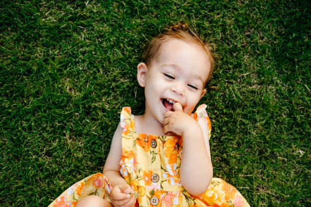 istock Happy Smiling Little Girl Lying On Grass 1179549326
