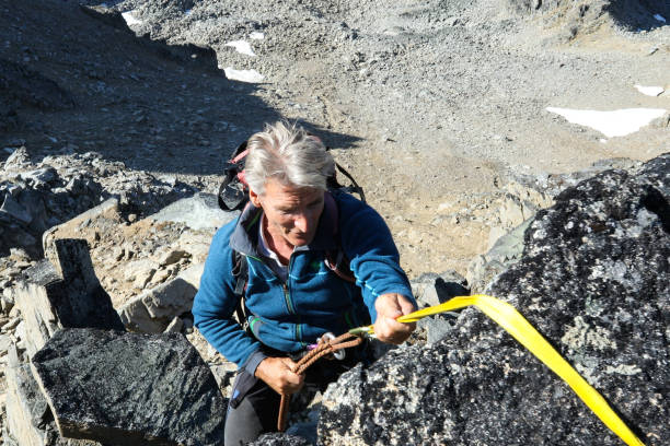 istock Mountaineer rappels down rock face 1179549391
