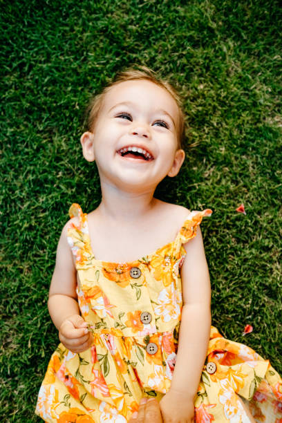 istock Happy Smiling Little Girl Lying On Grass 1179549703