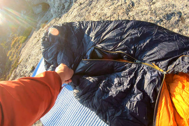 istock Young man camping prepares spot to sleep in 1179550769