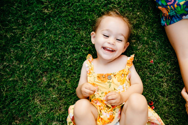 istock Happy Smiling Little Girl Lying On Grass 1179550802