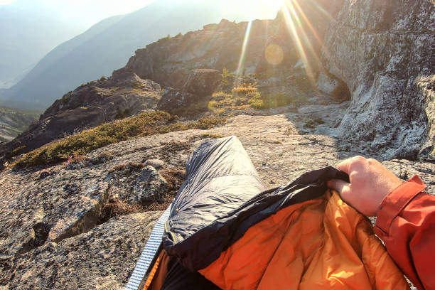istock Young man camping prepares spot to sleep in 1179551164