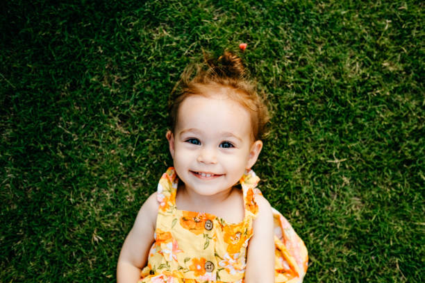 istock Happy Smiling Little Girl Lying On Grass 1179551592