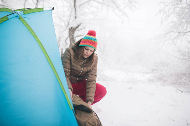istock Woman inside tent set in winter hiking 1179552344