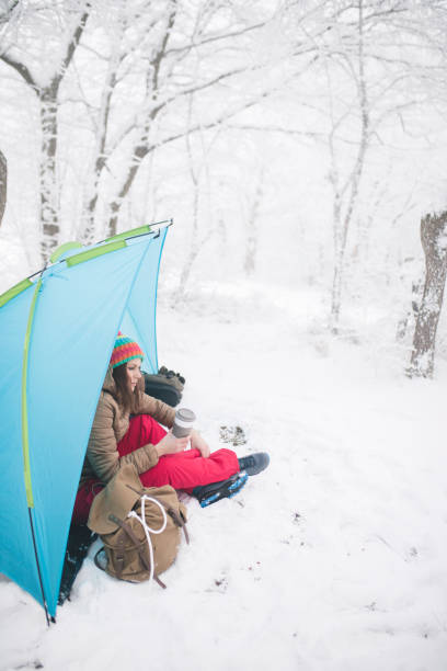 istock Woman inside tent set in winter hiking 1179552986