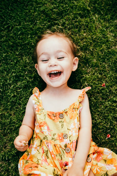 istock Happy Smiling Little Girl Lying On Grass 1179553130