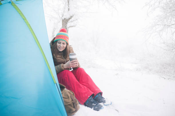 istock Woman inside tent set in winter hiking 1179553974