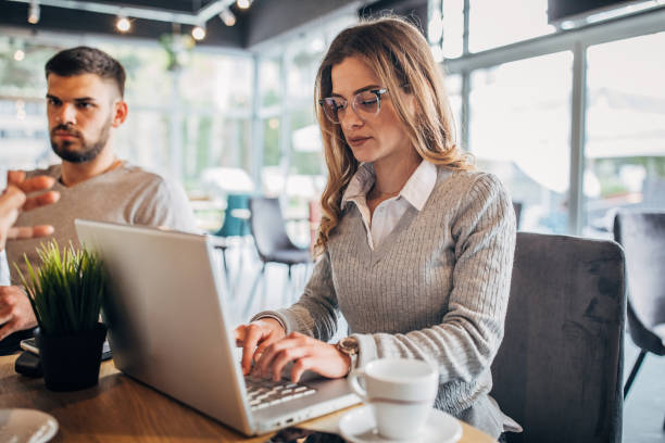 istock Man and woman using in cafe together 1179554099
