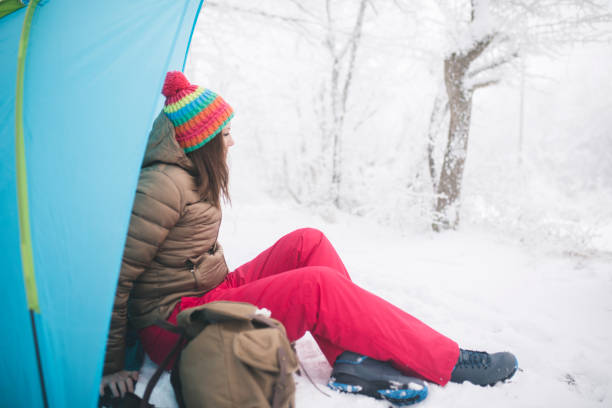 istock Woman inside tent set in winter hiking 1179554248
