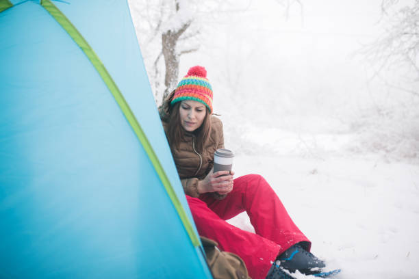 istock Woman inside tent set in winter hiking 1179554512