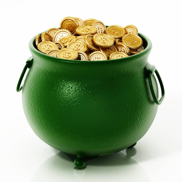 istock Gold coins inside green cauldron isolated on white 1179556378
