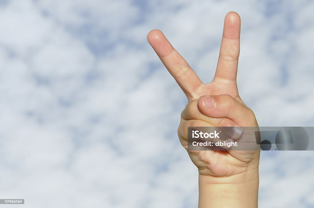 v sign victory sign by a child over cotton cloud blue sky.  Other hand series:  http://www.istockphoto.com/file_search.php?action=file&lightboxID=4841702 Blue Stock Photo