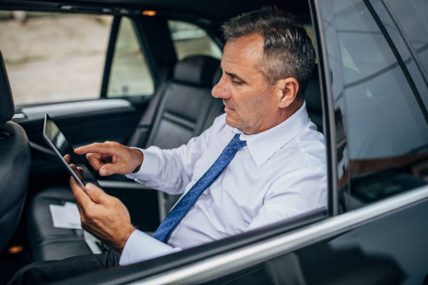 istock Business in the car on digital tablet 1179559088